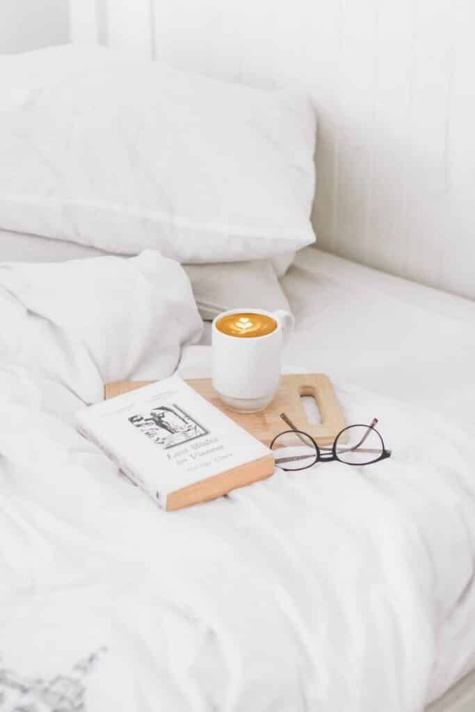 book-coffee-and-glasses-on-bed